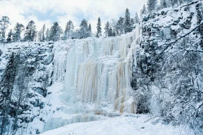 Hike through korouoma canyon’s frozen waterfalls with a local guide, enjoy a fire-cooked lunch, and get hotel pickup plus edited photos after the tour.
