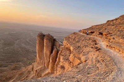 Watch sunset at edge of the world, hike with a local guide, and sip tea on a private 4x4 day trip from riyadh. includes water and flexible timing.