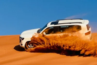 Private dubai desert safari with thrilling dune bashing, quad biking, camel ride, live shows & bbq dinner. includes pickup, local guide, and stargazing session.