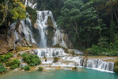 Journey by boat from luang prabang to pak ou caves, visit kuang si waterfall, and explore local villages with a friendly guide. includes lunch and hotel pickup.