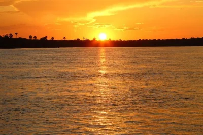 Drift along the zambezi river at sunset near victoria falls, spot hippos and wildlife, enjoy snacks and local drinks. includes hotel pickup and expert guide.
