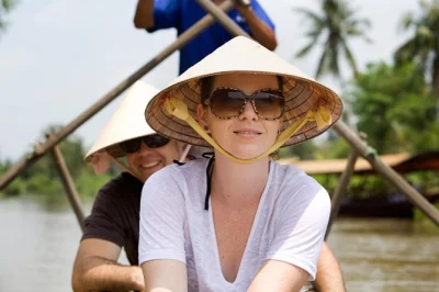 Travel from phnom penh to ho chi minh city by private mekong delta river tour. cross the border, visit floating markets, pagodas, and bird sanctuaries. includes guide & hotels.