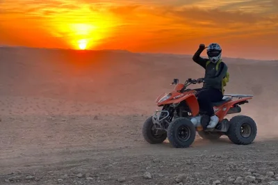 Experience the agafay desert near marrakech with quad biking, a camel ride at sunset, and moroccan dinner under berber tents. includes hotel pickup and guide.