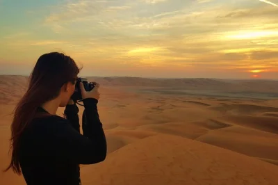 Experience the vast rub al khali dunes, sunset views, and a picnic lunch on this abu dhabi desert safari. includes pickup, local guide, and camel farm visit.