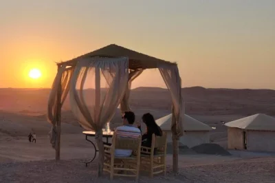 Experience a sunset camel ride in agafay desert from marrakesh, with berber hospitality, local dinner under the stars, and pickup included for easy booking.