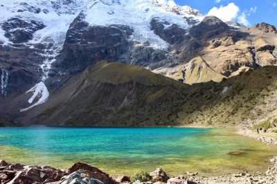 Experience a guided day trip from cusco to humantay lake with breakfast, local lunch, and hotel pickup. trek the salkantay route with expert guides and panoramic views.