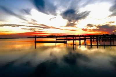 Experience sunset colors from the water near chincoteague and assateague islands, cruise with a local guide, and enjoy easy parking included for your evening tour.