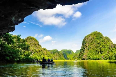 Explore ninh binh’s tam coc caves by rowing boat, cycle through villages, hike up mua cave for panoramic views, and visit hoa lu ancient capital. includes lunch & transport.