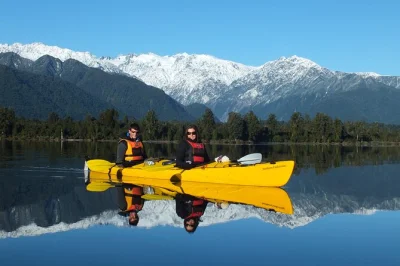 Feel the quiet of lake mapourika by kayak near franz josef glacier, paddle with a local guide, and explore untouched rainforest—includes pickup and all gear.