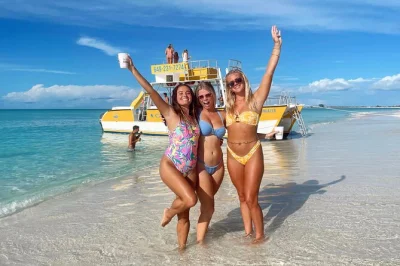 Step onto your own private boat from grace bay, snorkel vibrant reefs, sip rum punch on half moon bay, and meet local iguanas—includes pickup, open bar, lunch.