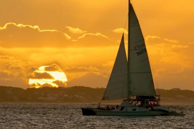 Sail from grace bay in turks & caicos on a sunset catamaran cruise with champagne, local appetizers, and music. includes beachfront pickup and adult-only atmosphere.