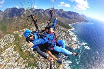 Feel the wind above cape town with a tandem paragliding flight, see table mountain and lion’s head, photos included, transfer back to meeting point.