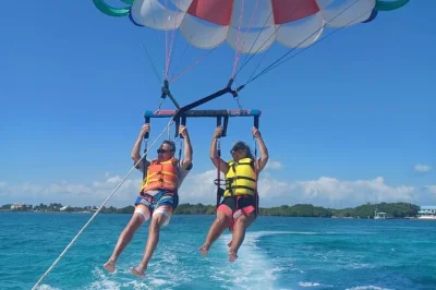 Feel the wind as you parasail above ambergris caye’s caribbean sea, spotting turtles and rays below. includes safety-trained crew, option for water dip, and all fees.