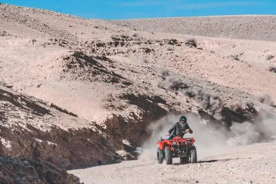 Feel the wind in your face riding top-notch atvs through agafay desert hills near marrakech, starting from a real oasis. includes pickup, guide & local snack.