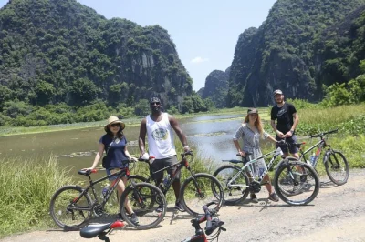 Cycle hanoi’s red river delta, cross long bien bridge, visit co loa citadel, meet locals, and explore hidden villages. authentic rural vietnam bike tour.
