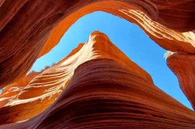 Feel the sand shift under 4x4 wheels, walk inside peek-a-boo slot canyon, and spot ancient petroglyphs on a private tour with a seasoned local guide. includes water.