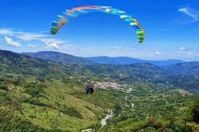 Feel the rush of paragliding, climb el peñol rock, and wander guatape’s colorful streets on a private day trip from medellin with hotel pickup included.