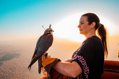 Über der margham-wüste in dubai bei sonnenaufgang schweben, eine falkenshow im flug erleben und ein traditionelles beduinen-frühstück mit kamelritt genießen. inklusive hoteltransfer.