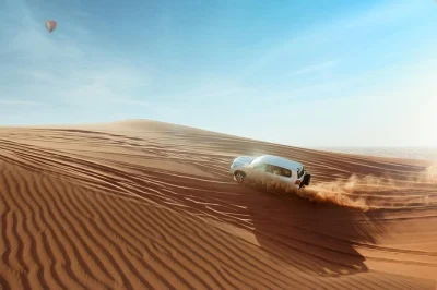 Feel the dubai desert come alive with dune bashing, sandboarding, camel rides, live shows and a bbq dinner. includes hotel pickup by 4x4 and sunset photo stops.