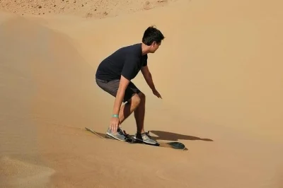 Feel the rush of sandboarding near agadir, sip mint tea in a berber home, and watch sunset over taboga dunes. includes pickup, breakfast, and all gear.