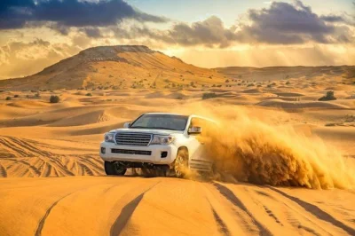 Feel the thrill of dubai’s red dunes on a desert safari with dune bashing, camel rides, sandboarding, and a bbq dinner under the stars. includes hotel pickup.