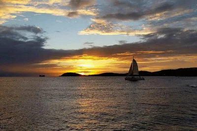 Feel the breeze on a st thomas sunset sail around charlotte amalie harbor, with open bar, appetizers, and friendly crew. includes pickup at marriott’s frenchman’s cove.