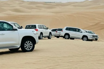 Feel the rush of dune bashing near abu dhabi, try sandboarding, ride camels, enjoy a bbq dinner with belly dance & fire shows. includes hotel pickup.