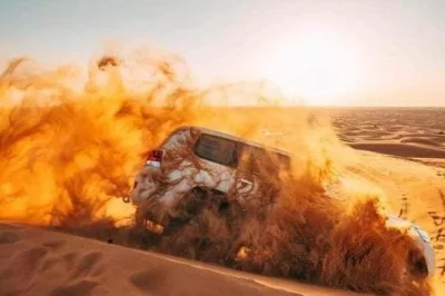 Feel the rush of dune bashing near dubai, try sand boarding, watch live belly dance & fire shows, and enjoy a bbq buffet dinner with hotel pickup included.