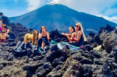 Ride calm rescue horses up guatemala’s pacaya volcano, taste pizza cooked on hot lava, and share laughs with locals. private tour with pickup and gourmet meal.
