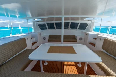 Sail from cancun to isla mujeres on a catamaran with snorkeling at el meco reef, island time, and private beach club access—includes open bar, lunch, and pickup options.