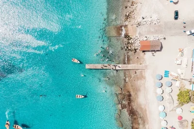 Feel the cool air in hato caves, swim with sea turtles at playa piskado, and unwind on porto mari beach—includes pickup and local guide for a stress-free day.