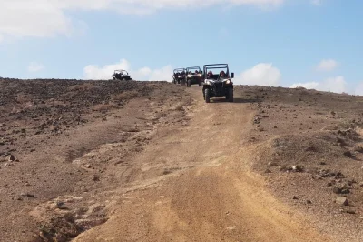 Feel the lanzarote wind on a guided buggy tour through volcanic landscapes, tiny villages, and old quarries. small group adventure with pickup and local guide.