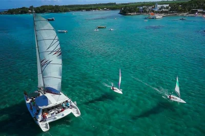 Feel the breeze on a full-day catamaran cruise to Île aux cerfs, with bbq lunch, drinks, snorkeling gear, and local crew. includes pickup from pointe jerome.