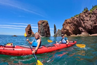 Feel the wild bay of fundy coast by kayak, paddle beneath the three sisters sea stacks, explore sea caves, and enjoy a homemade picnic—guide included.