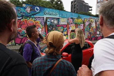 Feel the rhythm of medellin’s el poblado—street art, local bites, & craft beer with a guide. includes stops at lleras park, cuadroacuadro, and live music.