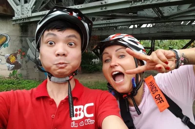 Cycle hanoi at sunrise, cross long bien bridge, join locals at hoan kiem lake, explore a bustling market, and enjoy authentic pho on this guided bike tour.