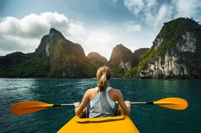 Feel the quiet of halong bay’s limestone peaks, kayak hidden coves, hike titop island for sweeping views, and explore surprise cave—all with hotel pickup from hanoi.