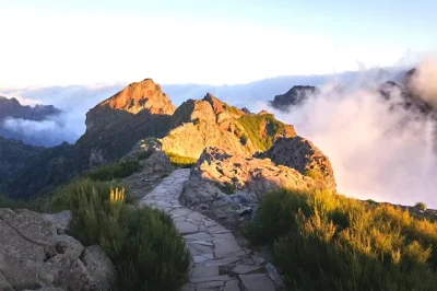 Watch the sunrise above madeira’s clouds on a guided pico do areeiro to pico ruivo hike, with hotel pickup and a small group for a quieter mountain morning.