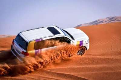 Feel the thrill of dubai’s desert safari with dune bashing, camel rides, live belly dance & bbq buffet. includes hotel pickup, drinks, and local guides.