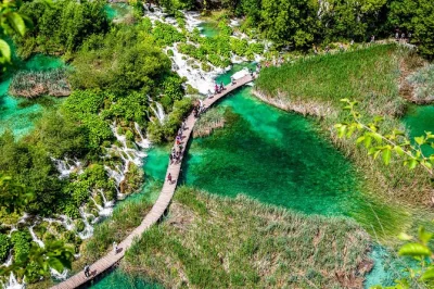 Lose yourself in the colors, sounds, and misty air of plitvice lakes on a guided day trip from split or trogir. includes entry, transport, and boat ride.