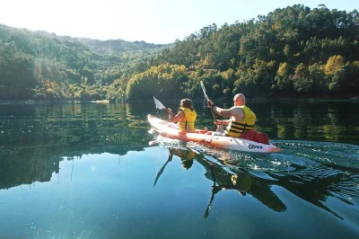Trade city noise for mountain air—kayak caniçada lake, swim at a hidden waterfall, and share local food with a small group. includes pickup from porto.