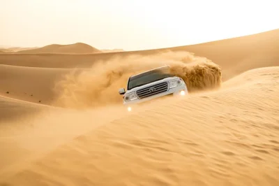 Feel the thrill of dune bashing near abu dhabi, try sandboarding, ride camels, and unwind at a desert camp with bbq dinner. includes pickup and local guide.