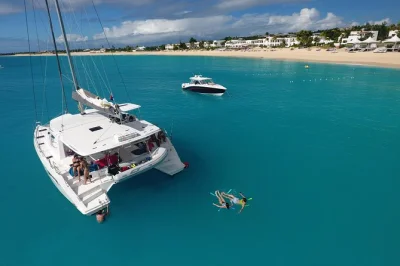 Sail st maarten’s coast on a luxury catamaran, stop at tintamarre island to swim with turtles, enjoy a 4-course lunch, open bar, and snacks—all with pickup included.