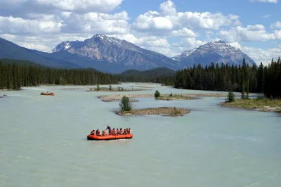 Float down jasper’s athabasca river with a local guide, pass gentle rapids, spot wildlife, and learn fur trade history—includes poncho, photos & all gear.