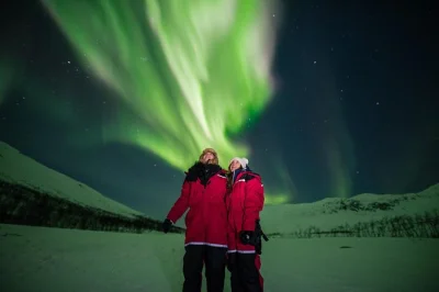 Feel the thrill of chasing the northern lights near tromso, warm up by a bonfire, enjoy snacks, and take home pro photos. includes thermal suits & pickup.