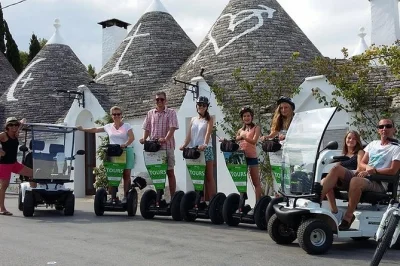 Erkunde alberobellos trulli-viertel mit segway oder mini-golf-cart, besuche ein echtes trullo und genieße die panorama-aussicht mit lokalem guide. alles inklusive ausrüstung.