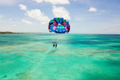 Feel the rush of parasailing over grace bay’s turquoise water in turks & caicos, with pickup right from the beach and a friendly local crew guiding you every step.