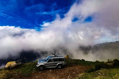 Feel the wild side of madeira on a 4x4 jeep tour—cabo girão skywalk, swim in porto moniz lava pools, and wander mystical fanal forest. includes pickup.