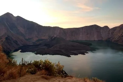 Wake up above the clouds on mount rinjani’s senaru crater rim, trek through rainforest with a local guide, camp overnight, and enjoy sunrise views. includes meals & gear.