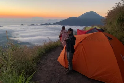 Watch sunset and sunrise from mount batur’s summit, camp overnight, enjoy dinner and breakfast cooked on the mountain, and relax at batur hot springs—includes pickup.